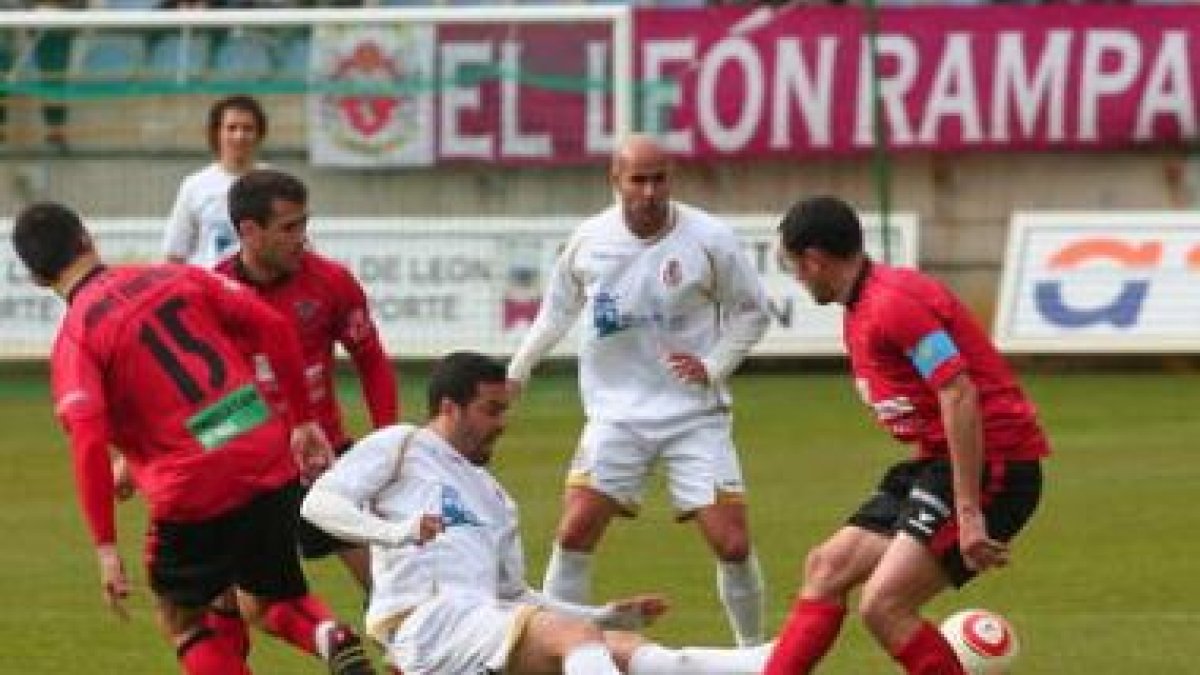 Marín, en el centro, cae ante la presencia de tres jugadores del Mirandés.