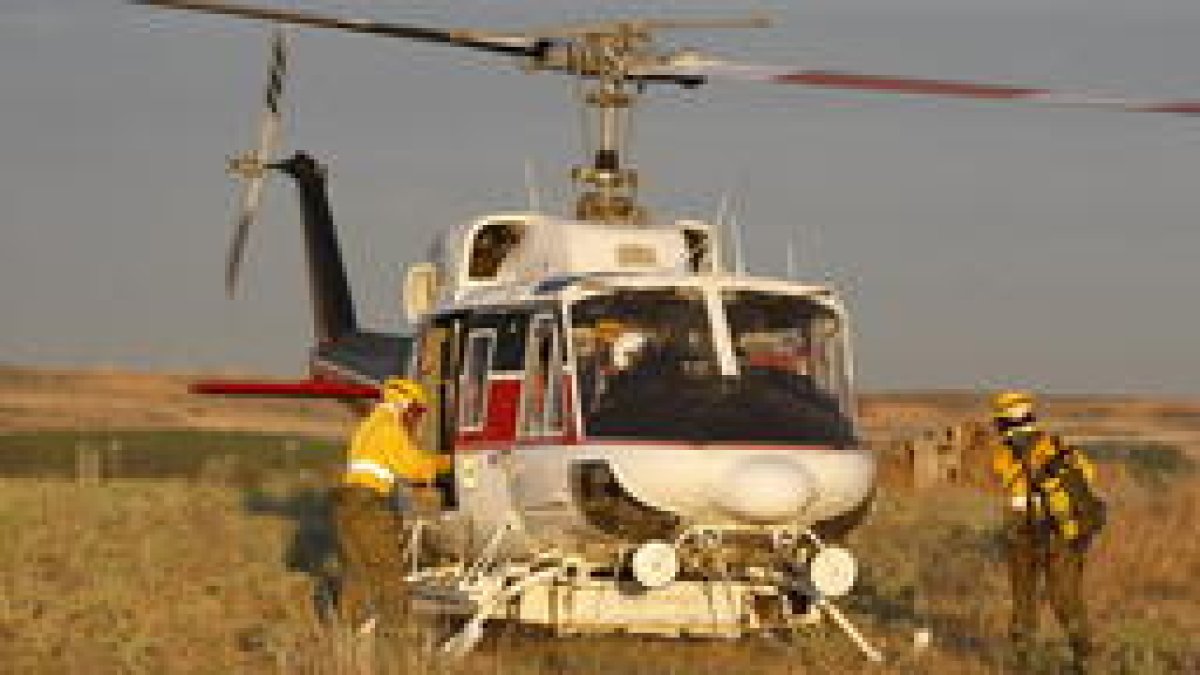 El helicóptero del servicio de incendios recoge a los efectivos.