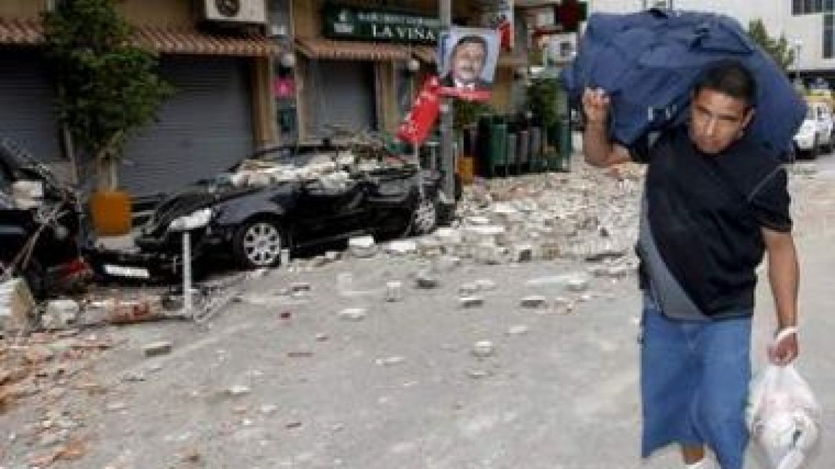 Un hombre traslada sus efectos personales en el barrio de Las Viñas de Lorca.