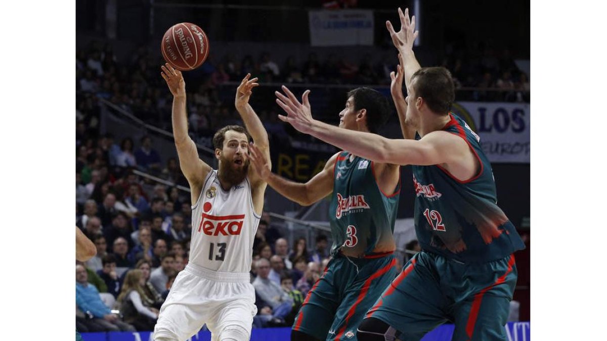 Sergio Rodríguez intenta una asistencia ante dos rivales.