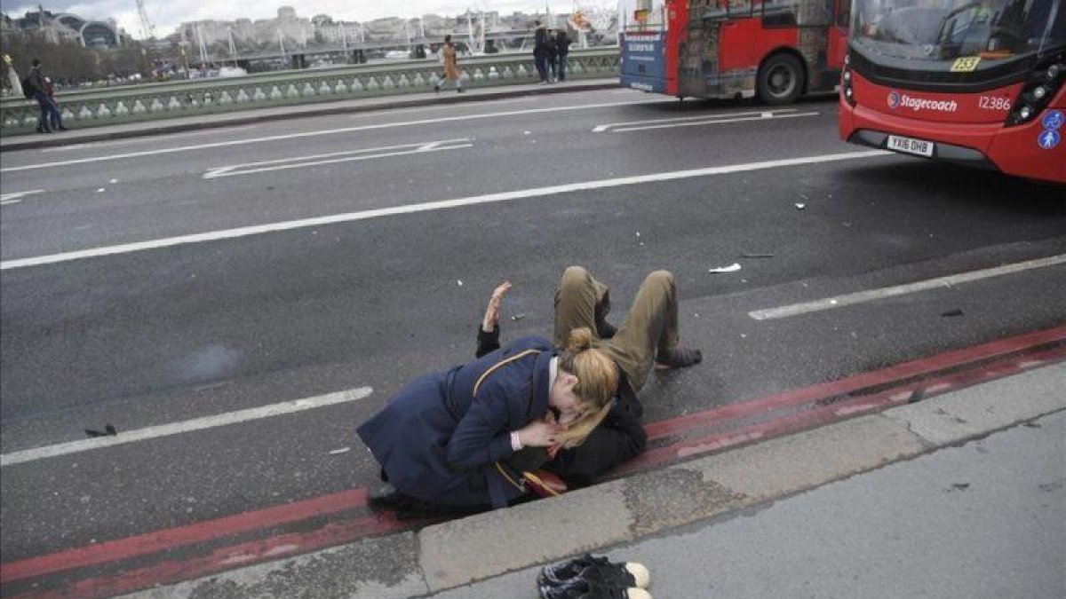Una mujer atiende a un herido en el puente de Londres.