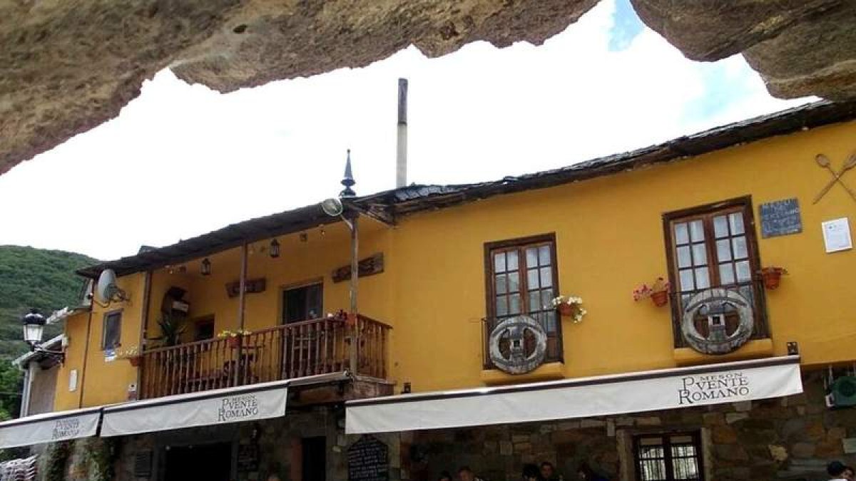 En las fotos puede verse el exterior del mesón, a orillas del río Meruelo y a los pies del puente romano de Molinaseca, y algunos de los platos elaborados en su cocina.