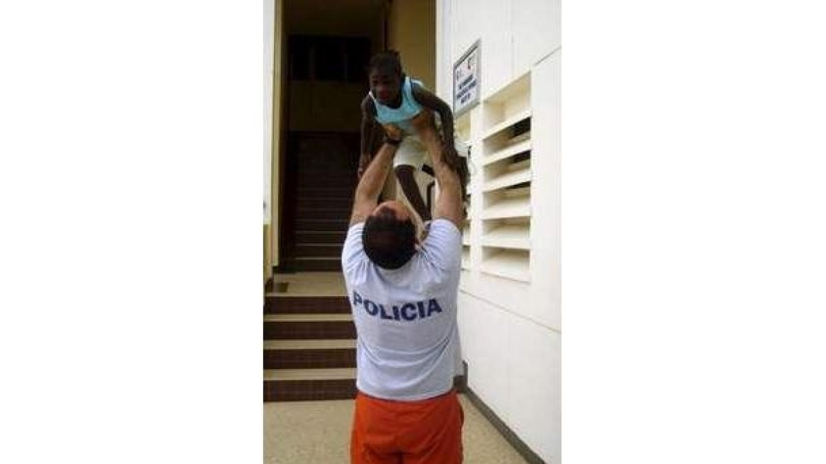 Un policía juega con un niño del orfanato «La Pouponnière».