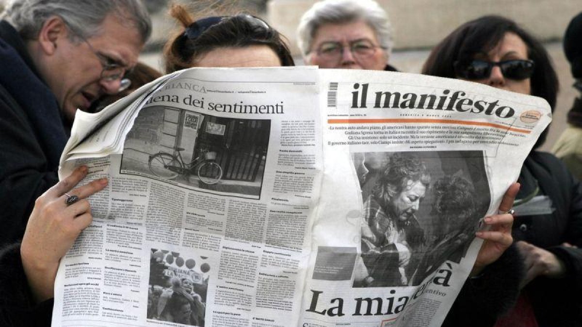 Una mujer leyendo el periódico italiano Il Manifesto.