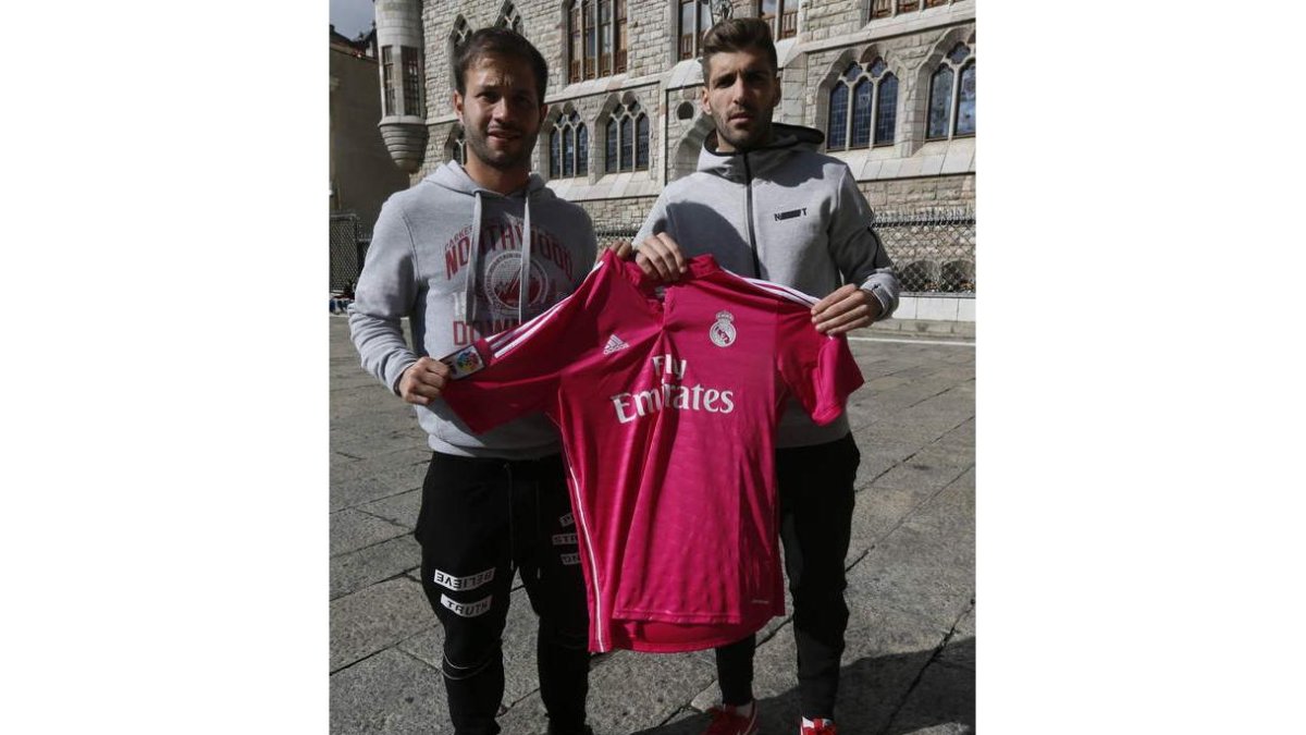 Con Botines al fondo, Antonio Martínez e Iván González sostienen la camiseta del Madrid. RAMIRO