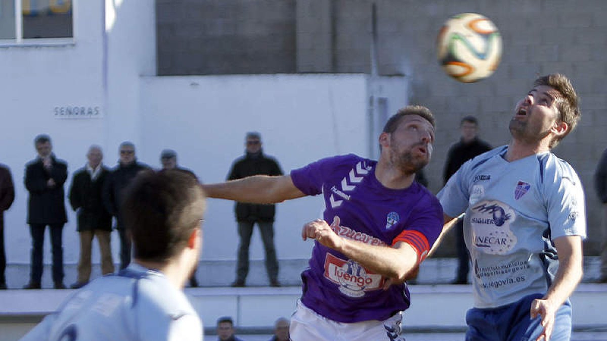 Ricardo remata de cabeza a pesar de la oposición de un jugador segoviano.
