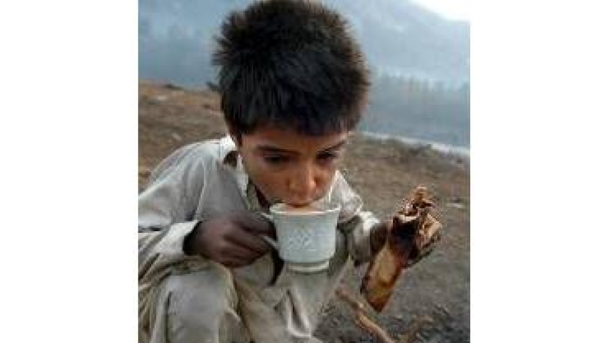 Un niño toma el desayuno en un campo de refugiados
