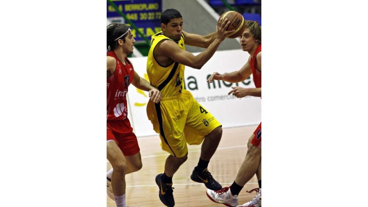 Manny Quezada, autor de 21 puntos, trata de superar la férrea defensa a la que fue sometido por el Iruña Navarra.
