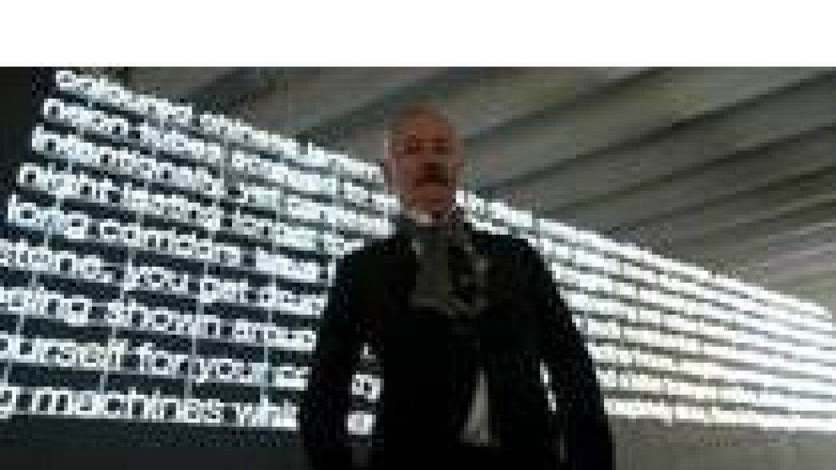 El galés Cerith Wyn Evans posa junto a una de las obras que exhibe el Musac hasta el domingo
