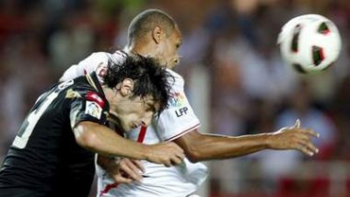 Luis Fabiano, a la derecha, lucha por el balón con el defensa argentino del Deportivo Colotto.