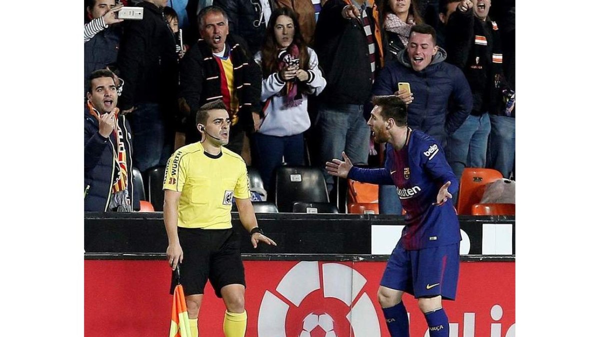 Messi protesta al juez de línea tras el gol que debió subir al marcador en la primera parte. MANUEL BRUQUE