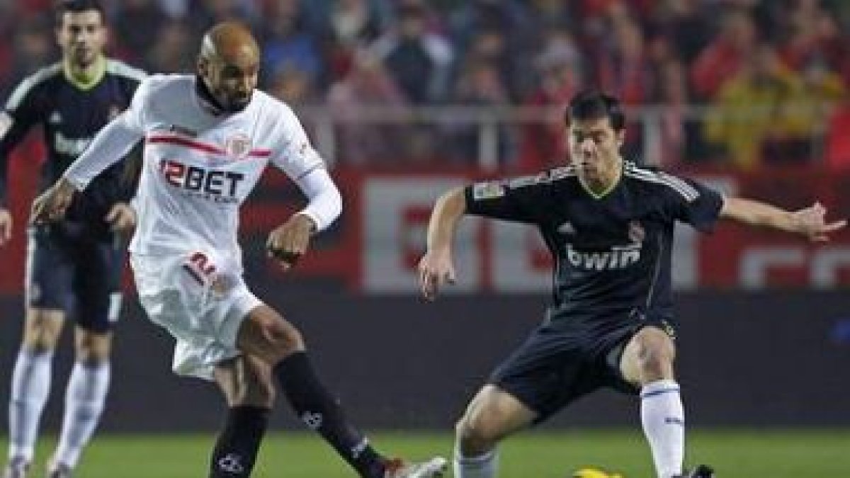 Xabi Alonso trata de repeler el disparo de Kanouté.