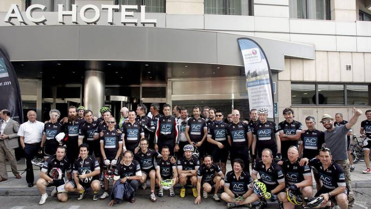 Los ciclistas posan con Miguel Induráin y Antonio Catalán a las puertas del hotel AC en León