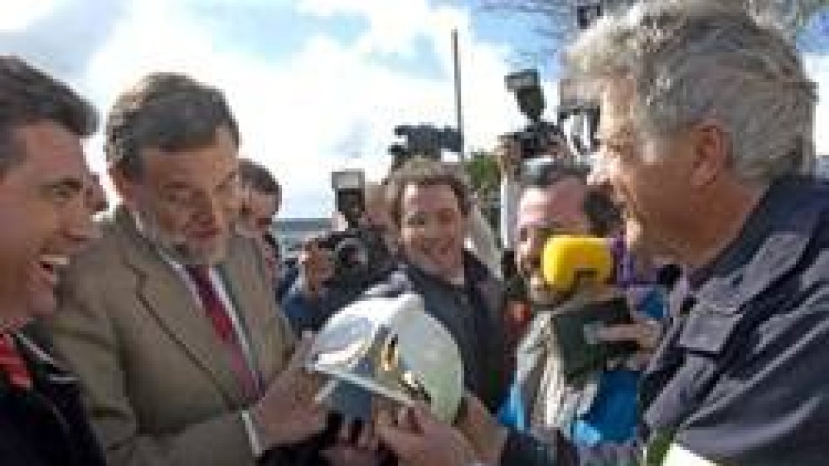 Rajoy recibe un casco de los bomberos de Aena, que también le dieron sus reivindicaciones laborales