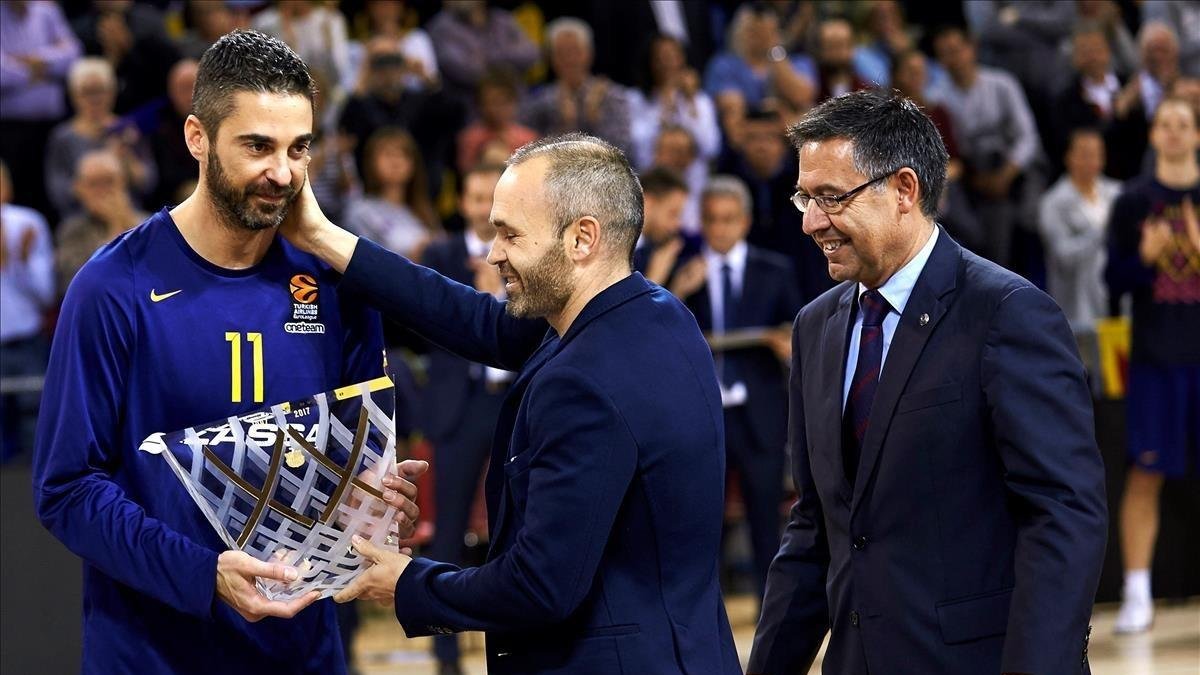 Navarro recibe una placa de manos de Iniesta y el presidente Bartomeu durante el homenaje por sus 20 años como azulgrana a finales del 2017 /