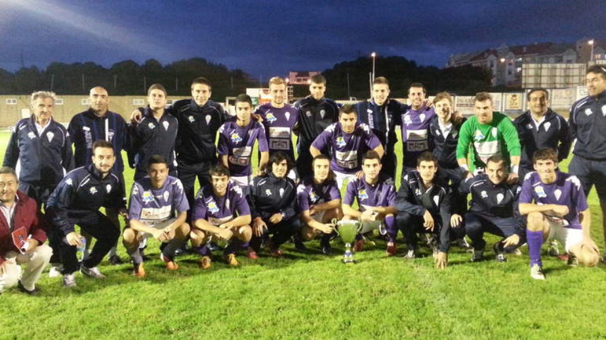La plantilla de La Bañeza con el trofeo conseguido en Candás.