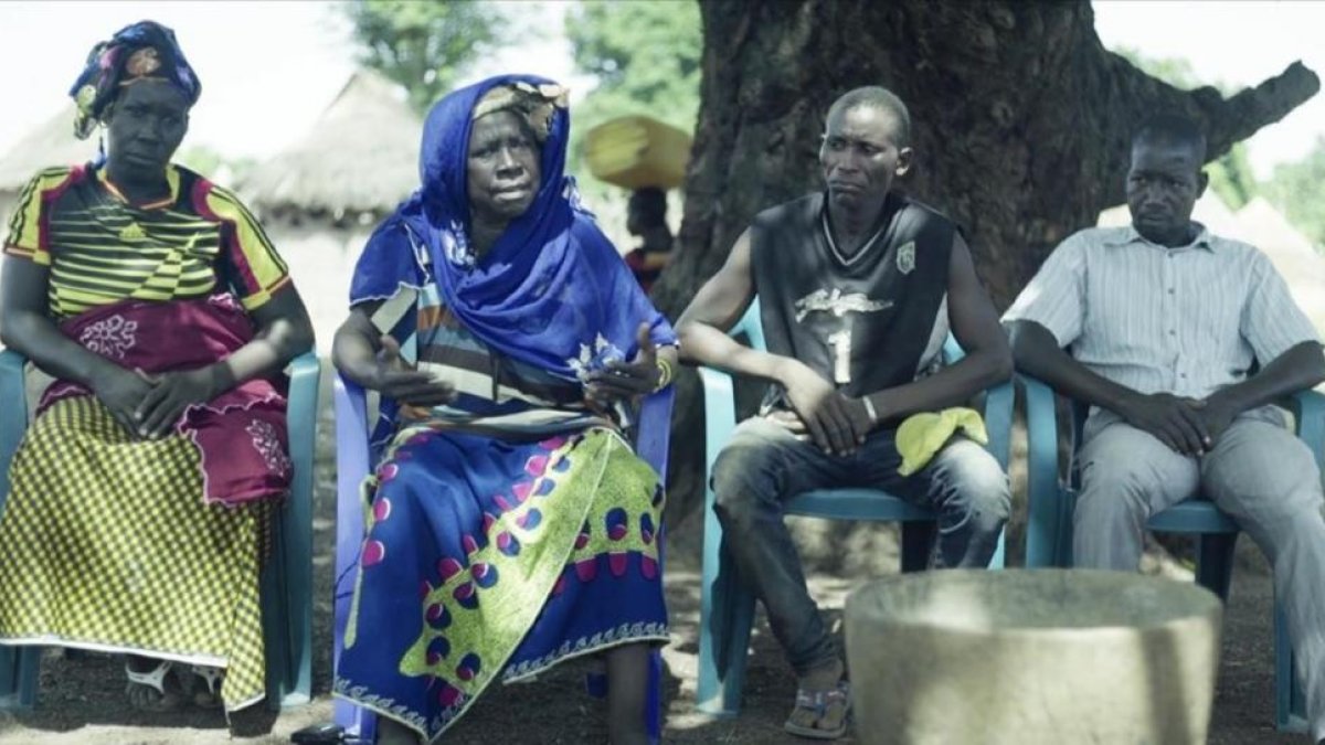 La familia de Idrissa, su madre Yasi, con vestido azul.