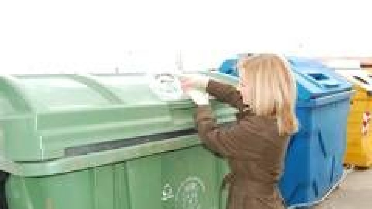 Una ciudadana deposita una bolsa de basura en un contenedor del municipio