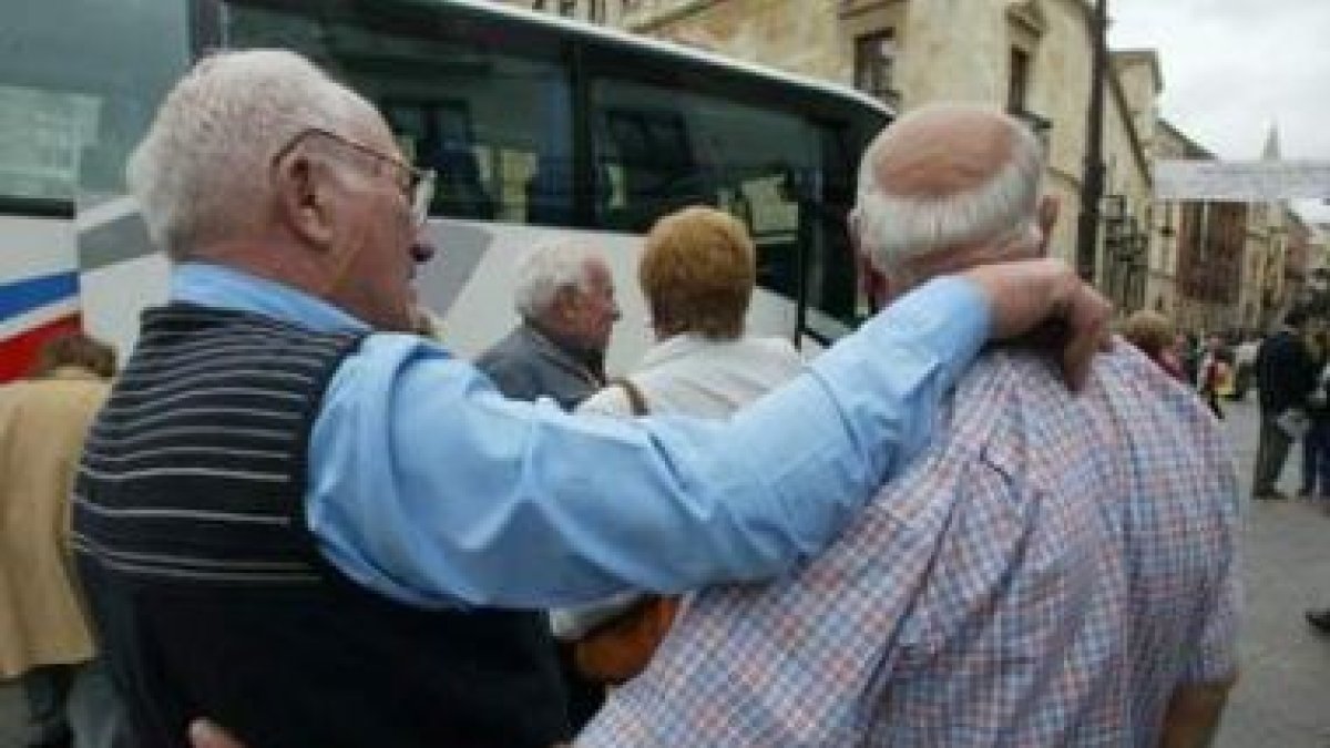 Jóvenes descendientes de emigrantes leoneses posan con Carrasco y varios diputados durante su estanc