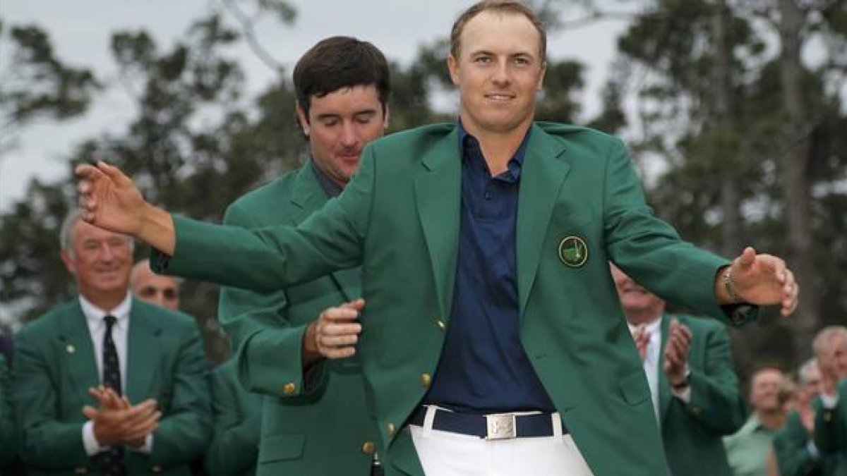 Jordan Spieth se enfunda la chaqueta verde de manos de Bubba Watson, vencedor en el 2014.