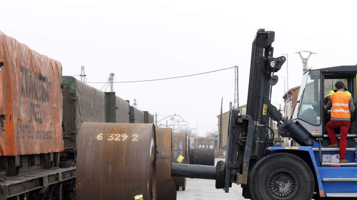 Operarios descargan bobinas de acero en el cargadero de Villadangos. MARCIANO PÉREZ