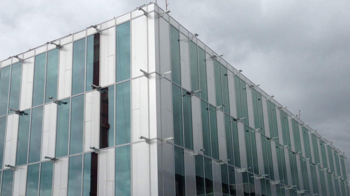 Edificio con el vidrio ya colocado, al que le falta la malla que lo recubre.