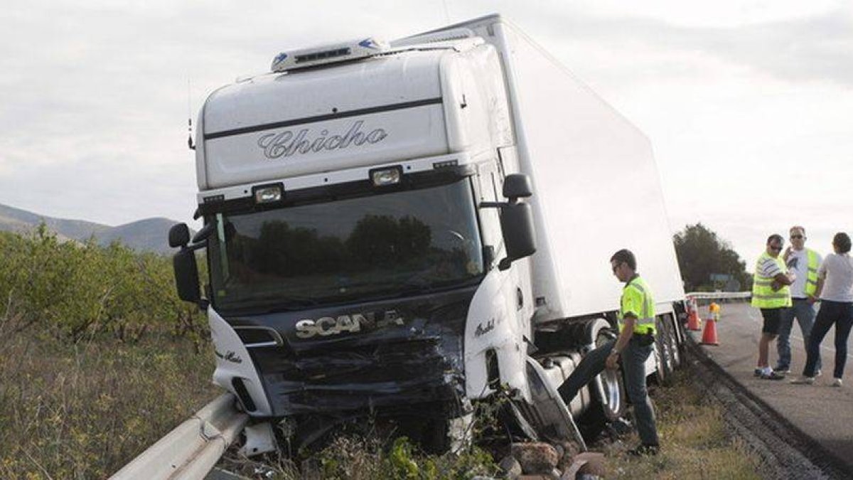 Agentes de la Guardia Civil investigan en el lugar del accidente ocurrido la madrugada del 14 de agosto de 2014 en el término municipal de Alcalá de Xivert (Castellón), al chocar un turismo contra un camión, en el que han muerto los cinco ocupantes del co