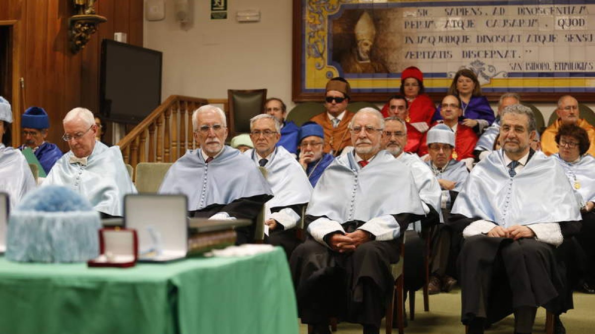 Los nuevos doctores, antes de ser investidos como tales, ante el mural que recuerda a San Isidoro, célebre erudito y doctor de la Iglesia.