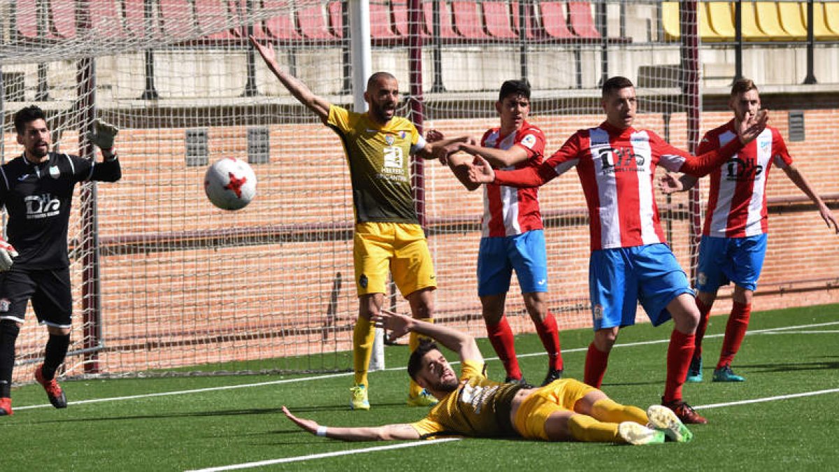 Los jugadores de la Deportiva reclaman un posible penalti en el área del Navalcarnero por una caída del central Fernando Román.