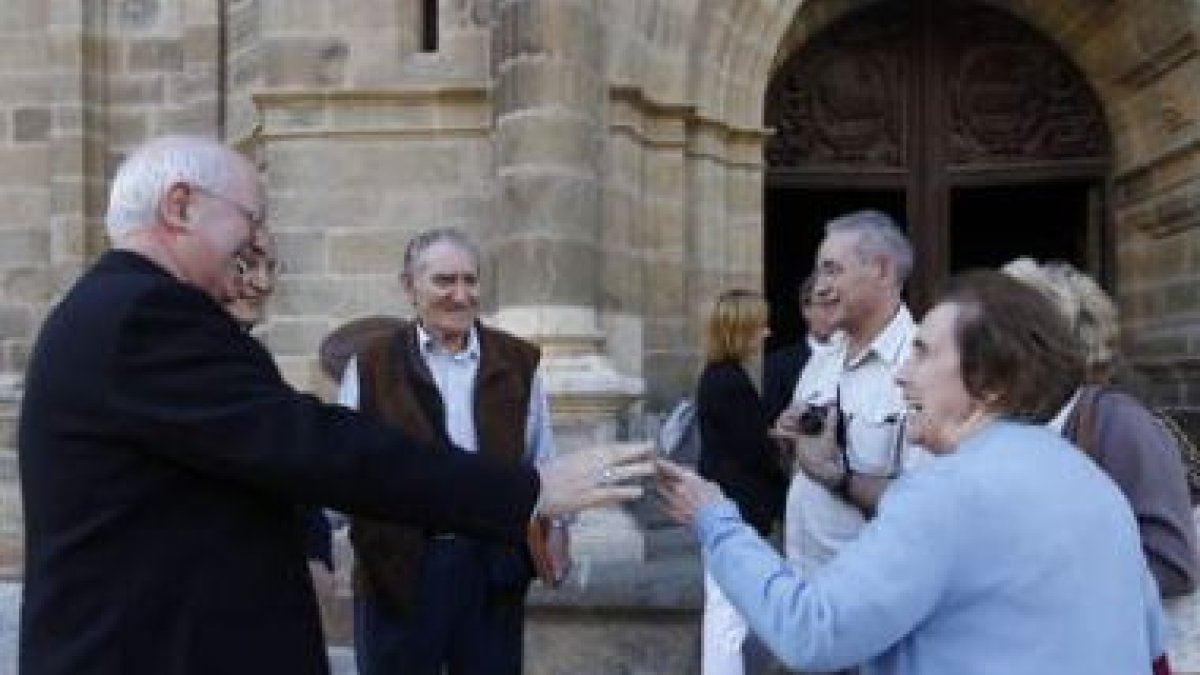 El arzobispo de Santiago saluda a unos feligreses antes de entrar en la catedral de Astorga.
