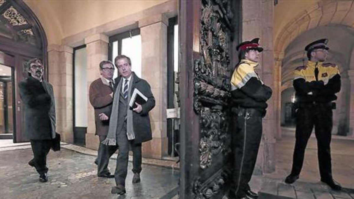 Jordi Pujol Ferrusola (con abrigo marrón) y sus abogados Cristóbal Martell y Albert Carrillo (con corbata de rayas), el 23 de febrero en el Parlament.