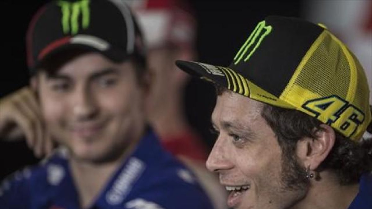 Lorenzo escucha sonriente a Rossi, en una rueda de prensa en Sepang.