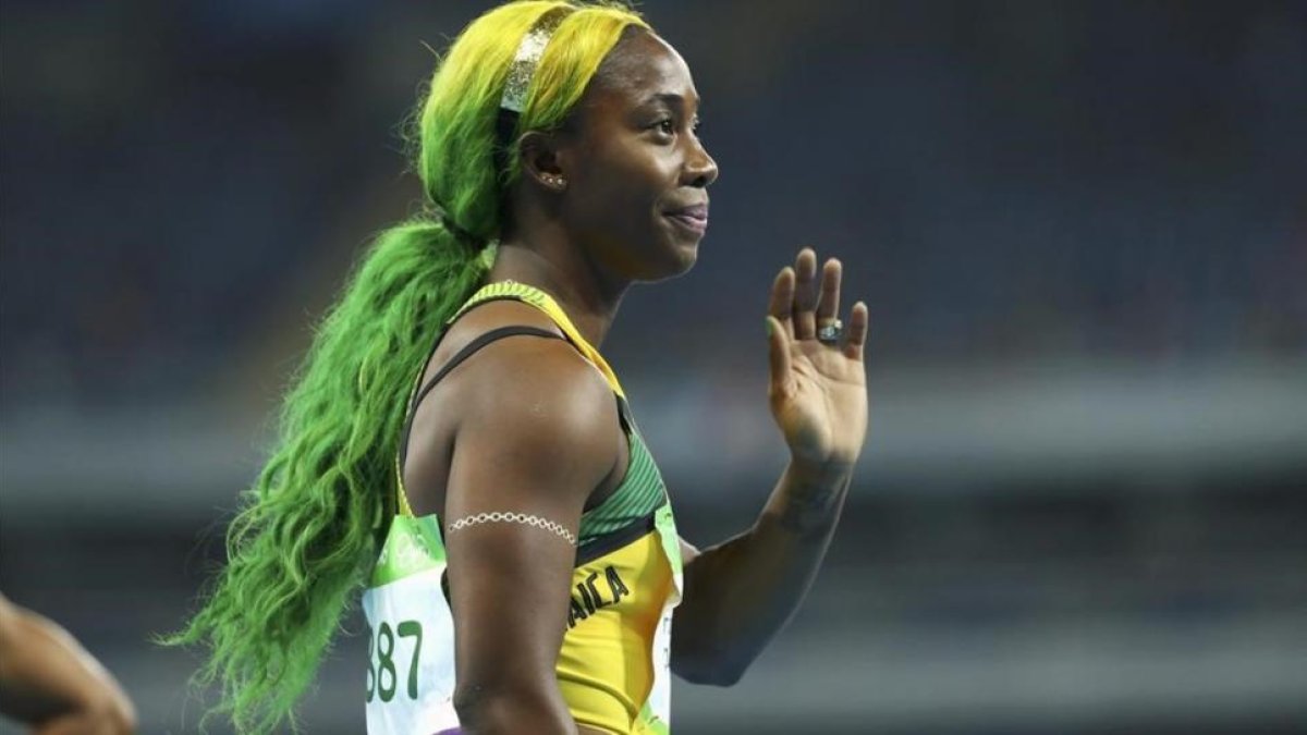 Fraser-Pryce, con los colores de la bandera jamaicana en el pelo.