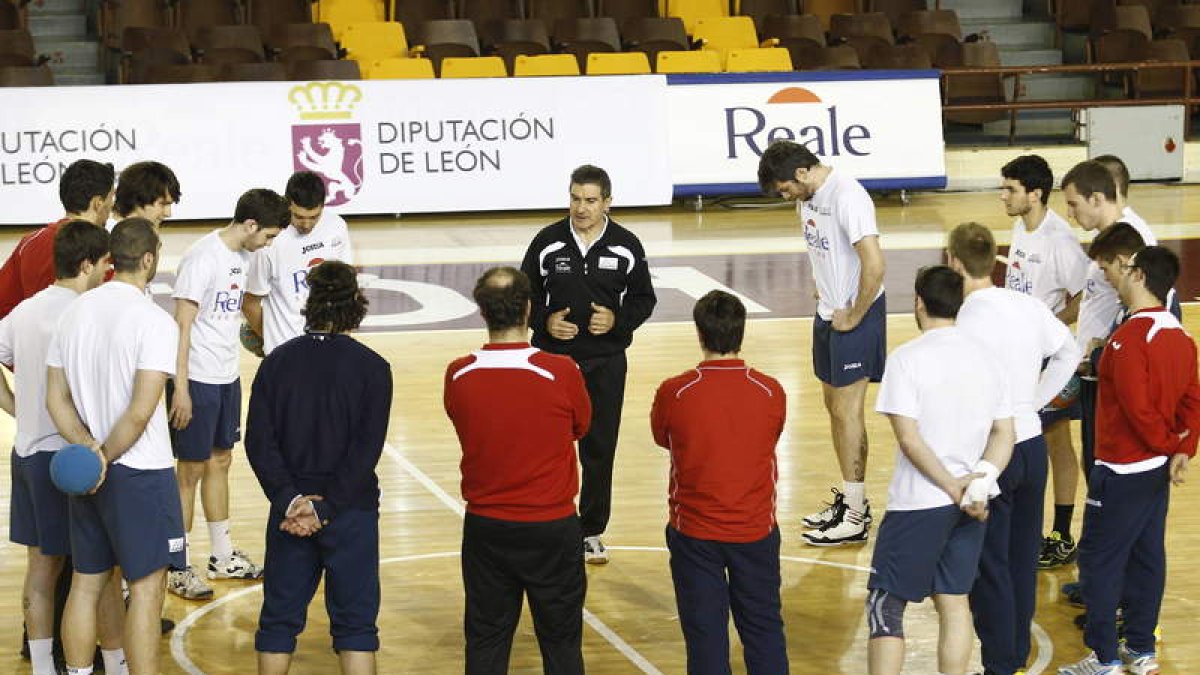 La plantilla del Ademar reunida en torno al técnico Manolo Cadenas en un entrenamiento.