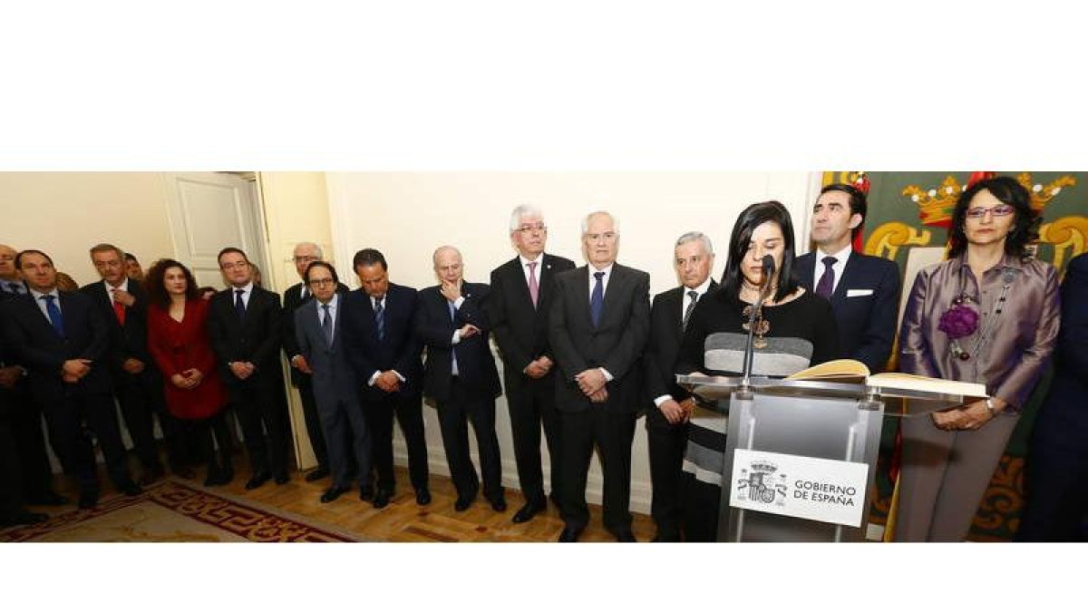 Diferentes personalidades de las que acudieron al acto observan cómo la secretaria de la Subdelegación da lectura al nombramiento.