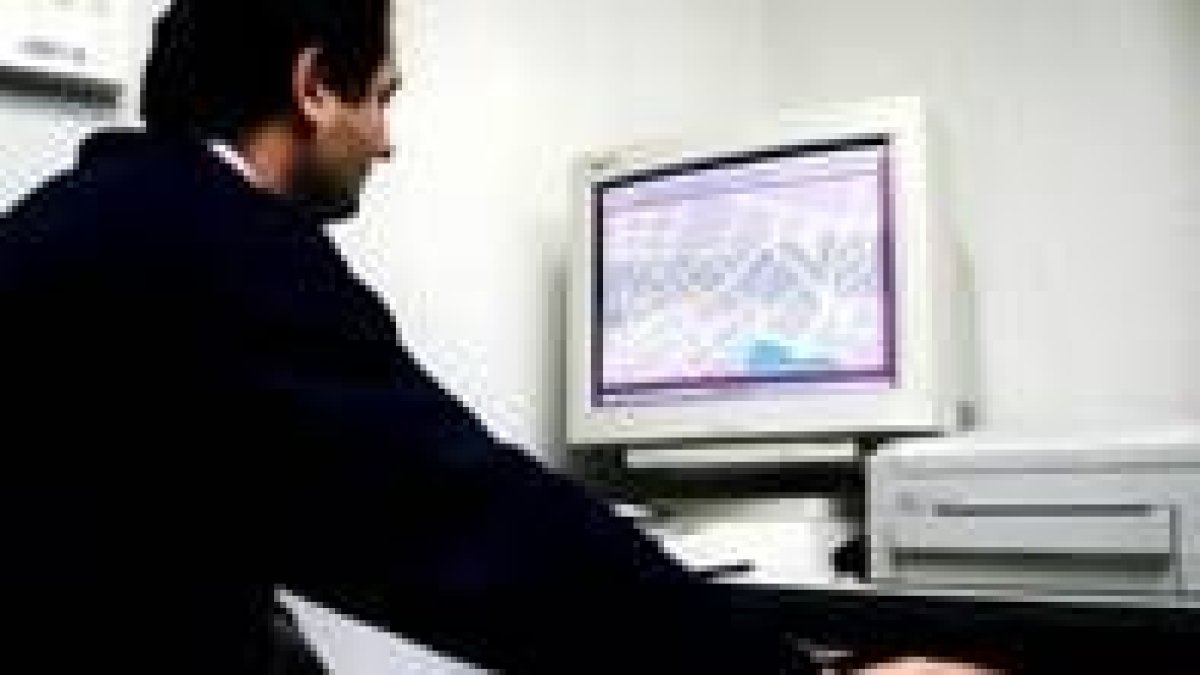 Un hombre maneja su ordenador, en su despacho