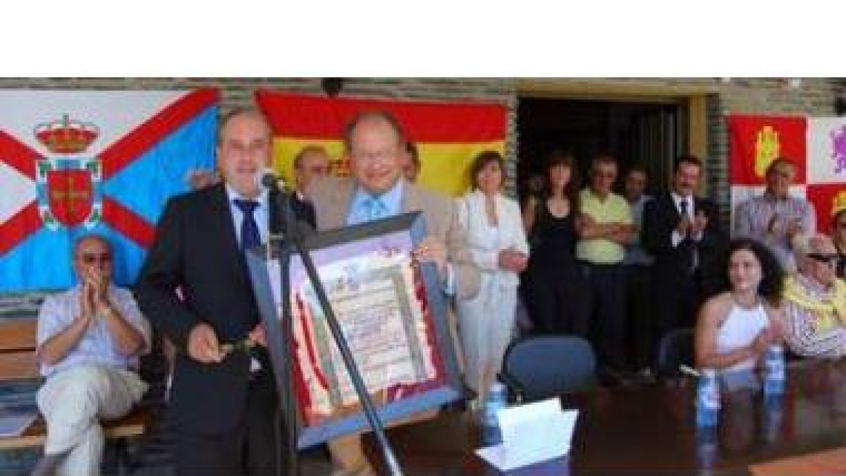 El delegado de la Junta en León recibiendo el título de Hijo Adoptivo de Fornela de la mano del alca