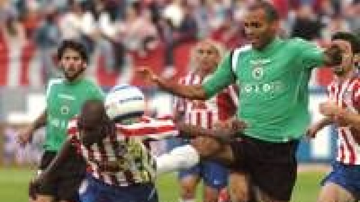 El delantero uruguayo del Racing Regueiro pelea por el balón con el defensa colchonero Luis Perea