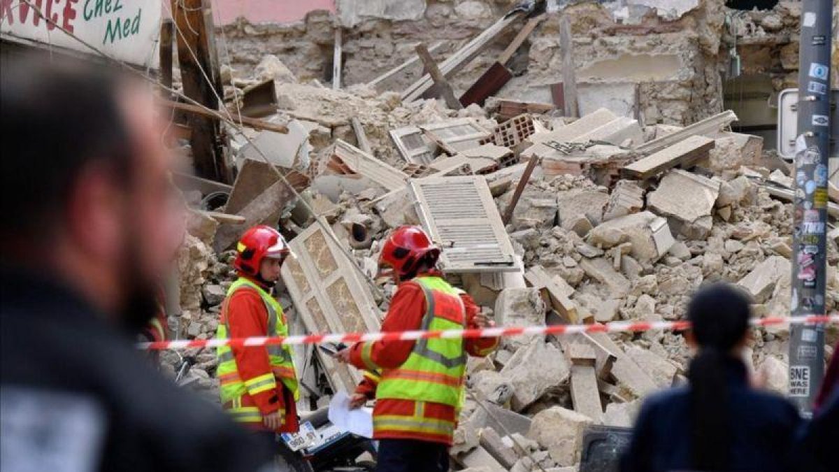 Bomberos y policías trabajan en el lugar en el que se han derrumbado dos edificios en Marsella, este lunes.