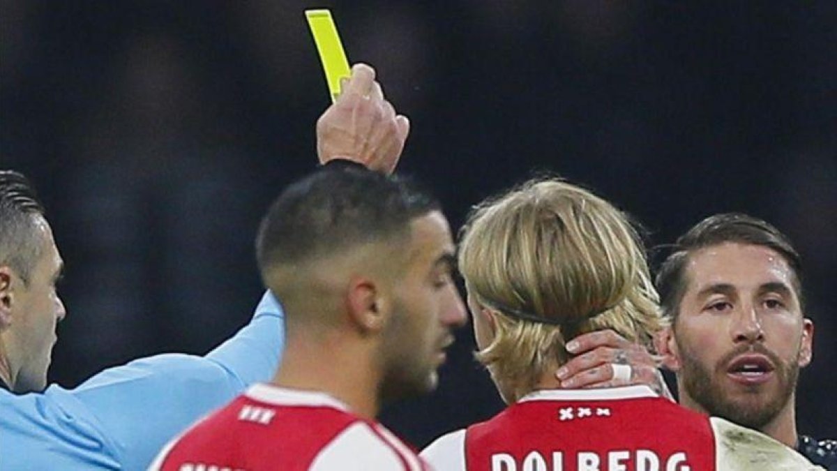 El árbitro Damir Skomina enseña la tarjeta amarilla a Sergio Ramos.