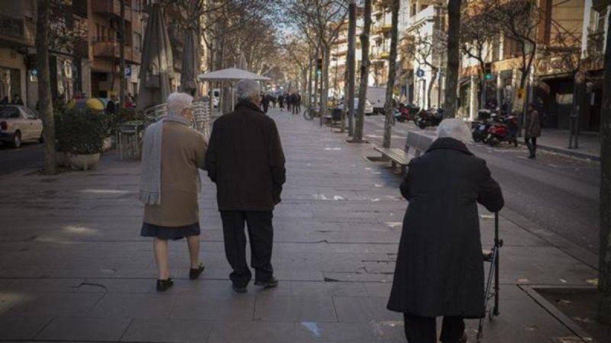 Un grupo de jubilados pasea por la Rambla de Barcelona.