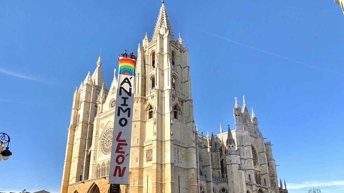 Bomberos y policías de León ante la catedral tras colgar la pancarta con la que transmitían su mensaje de ánimo a los leoneses. BOMBEROS DE LEÓN