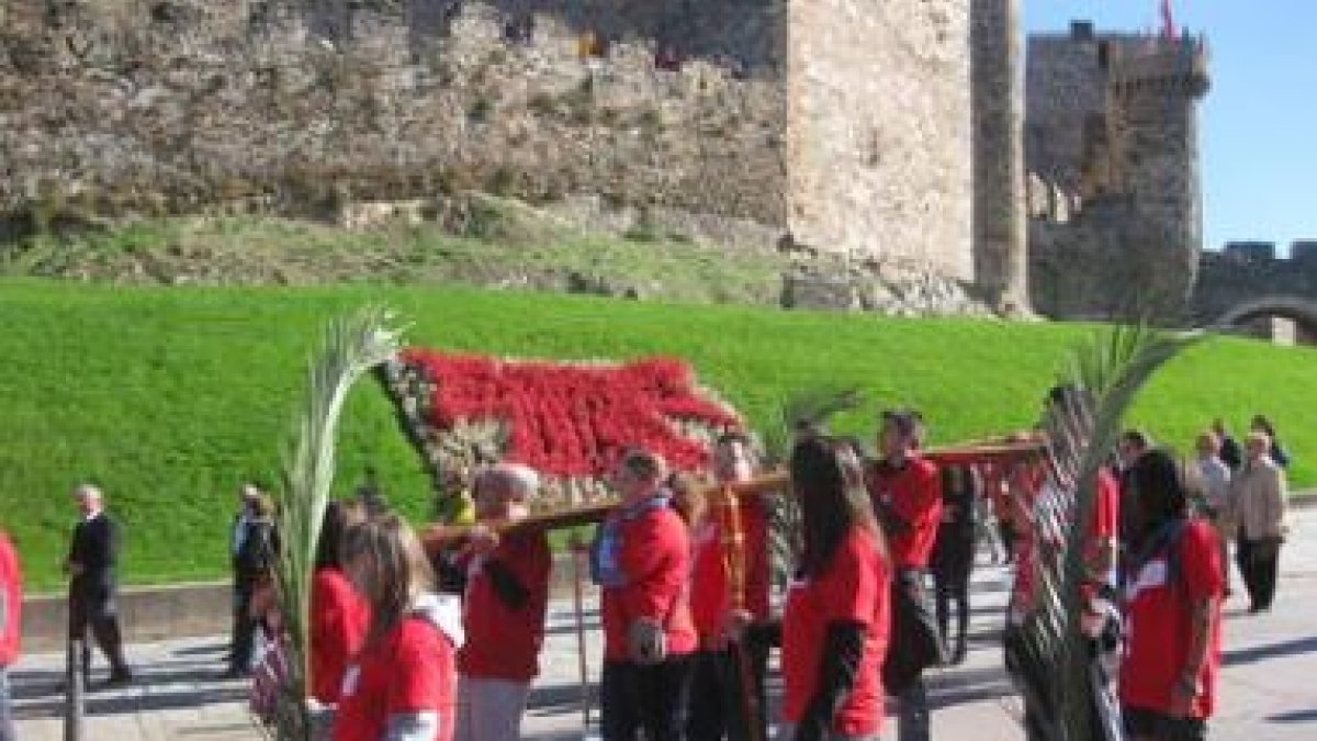 Un grupo de jóvenes portan la Cruz de Juan Pablo II a su paso por el Castillo de los Templarios.