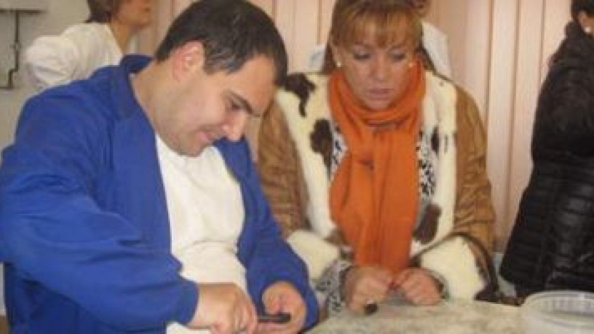 La presidenta, Isabel Carrasco, observa el trabajo realizado por uno de los residentes de Cosamai en