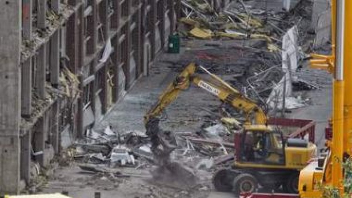 Obreros trabajan en la sede del edificio de gobierno, muy dañado por la explosión.