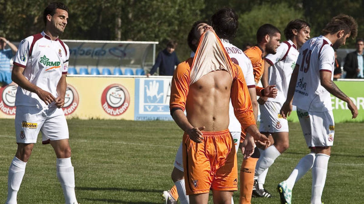 Murci, a la izquierda, celebra el gol de la victoria ante la desesperación del jugador local Juanma, que muerde la camiseta.