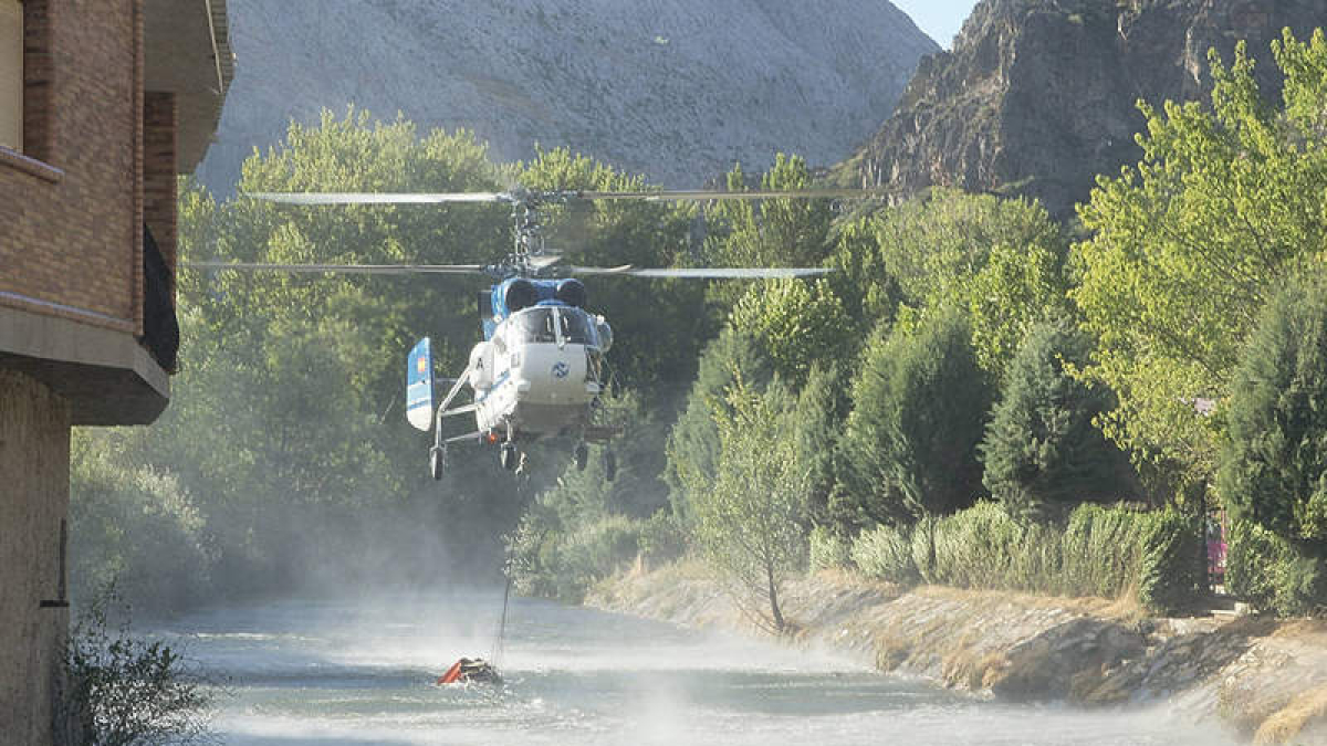 Uno de los helicópteros durante las labores de extinción del fuego en Cármenes.