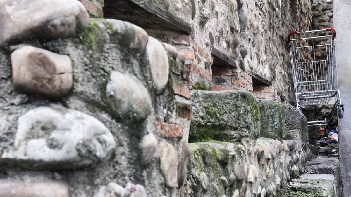 Un carro de supermercado incrustado en la Cerca Medieval, que sólo ha sufrido intervenciones de urgencia.