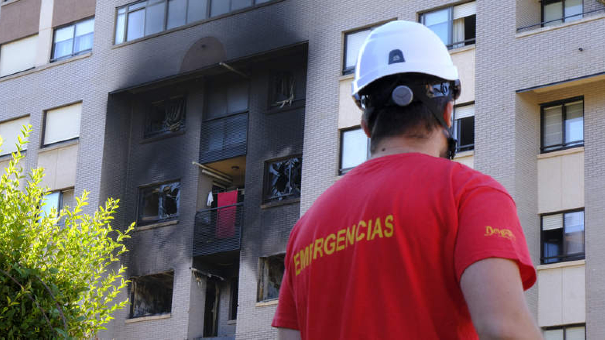 Un miembro del servicio de Emergencias ante el edificio siniestrado en Valladolid. FERNANDO SANZ