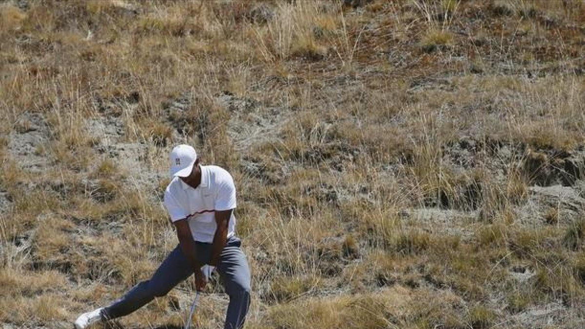 Tiger Woods trata de devolver la pelota a la calle en el octavo hoyo de Chambers Bay durante la segunda jornada del Abierto de EEUU.